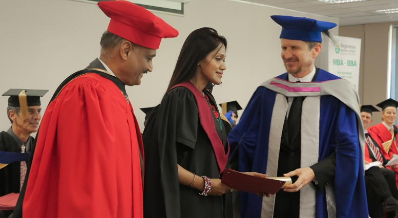 Bhaskar Pant of MIT congratulates a new program graduate in South Africa.